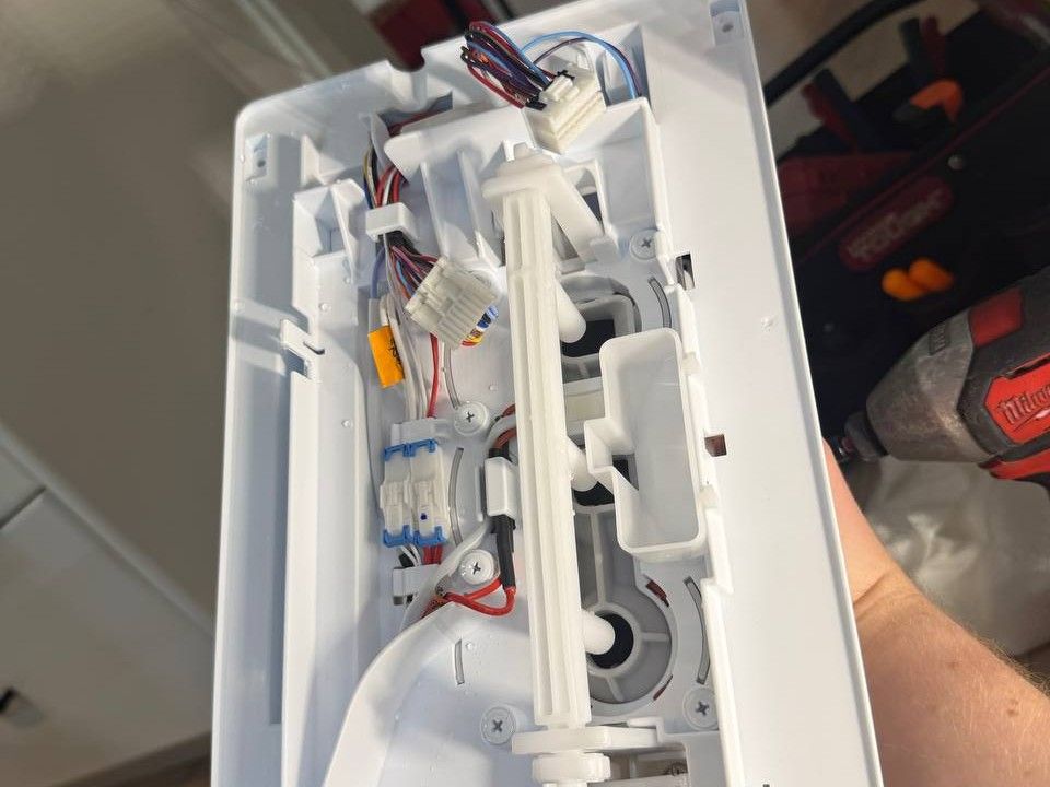 Ice maker assembly removed from an LG refrigerator for repair